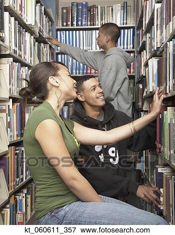 Group of friends in library View Large Photo Image Stock Photo - Group of friends in library. Fotosearch