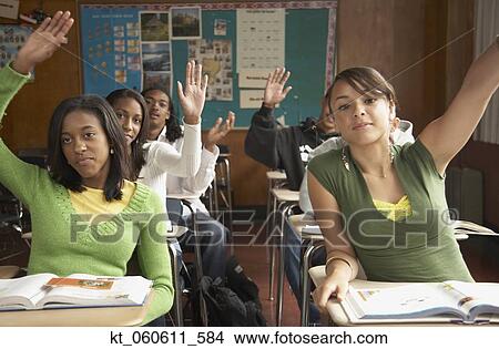 Group of students with hands raised in classroom View Large Photo Image Picture - Group of students with hands raised in classroom. Fotosearch