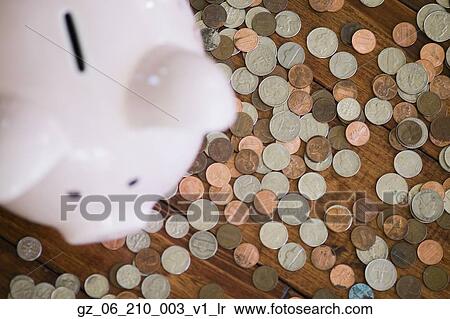 Stock Photography - High angle view of piggy bank surrounded by coins. Fotosearch