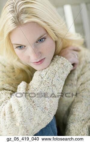 Stock Image - High angle view of young woman wearing sweater. Fotosearch
