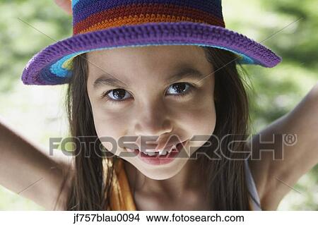 Picture - Hispanic girl smiling and wearing hat. Fotosearch