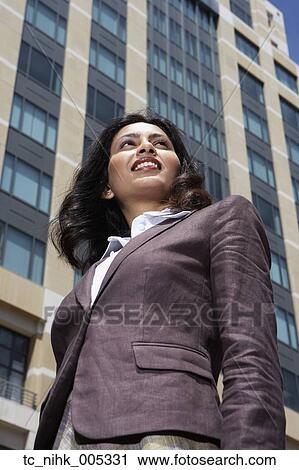 Low angle view of Indian businesswoman in urban scene View Large Photo Image Stock Image - Low angle view of Indian businesswoman in urban scene. Fotosearch