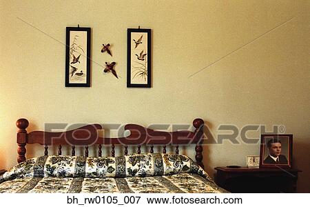 Made bed with pictures of birds on wall View Large Photo Image Stock Photo - Made bed with pictures of birds on wall. Fotosearch
