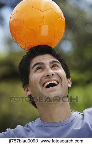 Man balancing soccer ball on head outdoors View Large Photo Image Stock Image - Man balancing soccer ball on head outdoors. Fotosearch