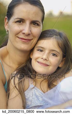 Mother and daughter hugging and smiling View Large Photo Image Stock Image - Mother and daughter hugging and smiling . Fotosearch