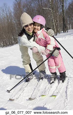 Mother and daughter smiling on skis View Large Photo Image Stock Photo - Mother and daughter smiling on skis. Fotosearch