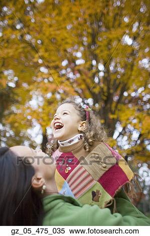 Mother and young daughter laughing outdoors View Large Photo Image Stock Photography - Mother and young daughter laughing outdoors. Fotosearch