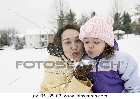 Mother and young daughter playing with snow View Large Photo Image Stock Image - Mother and young daughter playing with snow. Fotosearch