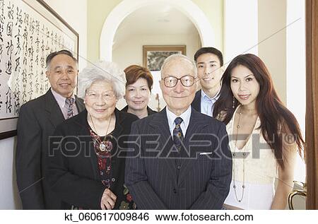 Multi-generational Asian family smiling indoors View Large Photo Image Stock Photograph - Multi-generational Asian family smiling indoors. Fotosearch