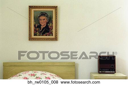 Stock Photo - Painting of woman on wall over bed. Fotosearch