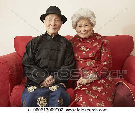 Senior Asian couple in traditional dress on sofa View Large Photo Image Stock Image - Senior Asian couple in traditional dress on sofa. Fotosearch