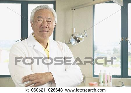 Senior Asian male dentist in office View Large Photo Image Stock Photo - Senior Asian male dentist in office. Fotosearch