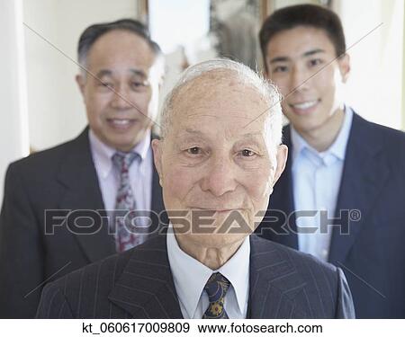 Senior Asian man with family members in background View Large Photo Image Stock Photo - Senior Asian man with family members in background . Fotosearch