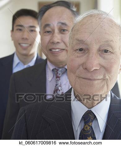 Senior Asian man with family members in background View Large Photo Image Stock Photograph - Senior Asian man with family members in background . Fotosearch