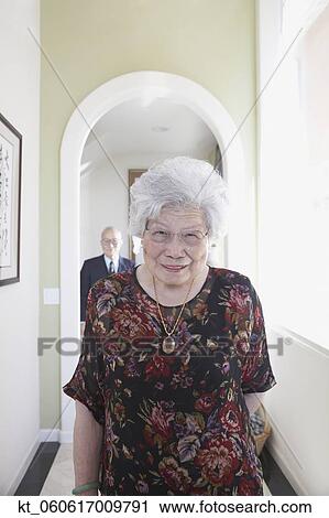 Senior Asian woman smiling in hallway View Large Photo Image Stock Image - Senior Asian woman smiling in hallway. Fotosearch
