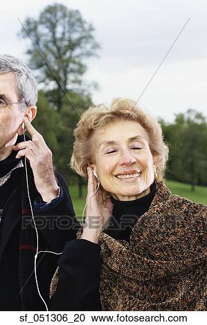 Senior couple listening to same mp3 player outdoors View Large Photo Image Stock Image - Senior couple listening to same mp3 player outdoors. Fotosearch