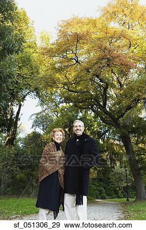 Senior couple smiling in park View Large Photo Image Stock Photo - Senior couple smiling in park. Fotosearch