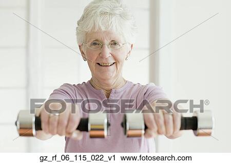 Senior woman lifting free weights View Large Photo Image Stock Image - Senior woman lifting free weights. Fotosearch