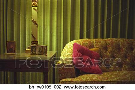 Sofa next to end table with photographs View Large Photo Image Stock Image - Sofa next to end table with photographs. Fotosearch