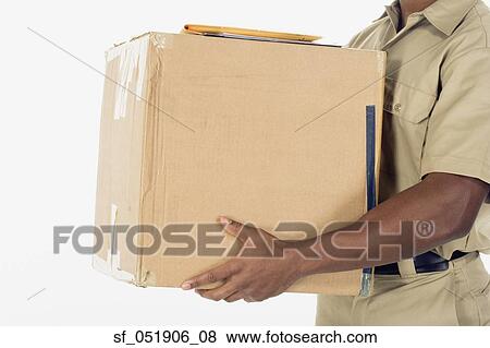 Stock Photo - Studio shot of African delivery man with package. Fotosearch