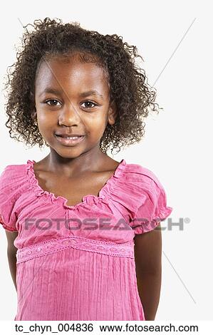 Stock Photograph - Studio shot of African girl smiling. Fotosearch