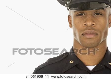Stock Image - Studio shot of African male police officer. Fotosearch