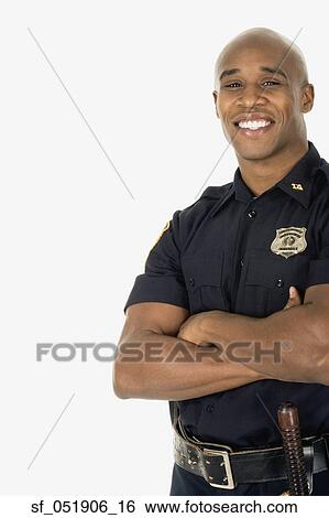 Stock Photograph - Studio shot of African male police officer smiling. Fotosearch