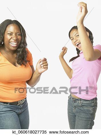 Studio shot of African mother and daughter dancing and laughing View Large Photo Image Stock Photography - Studio shot of African mother and daughter dancing and laughing. Fotosearch