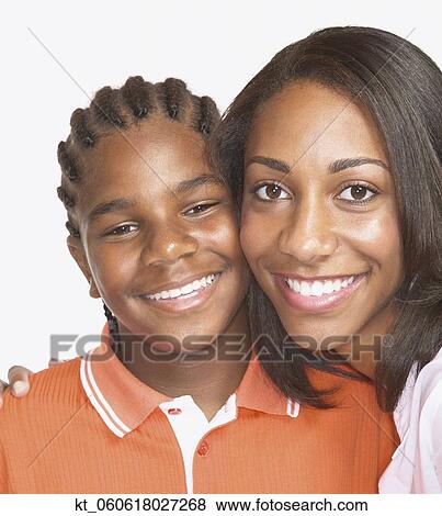 Studio shot of African mother hugging son View Large Photo Image Stock Photo - Studio shot of African mother hugging son. Fotosearch