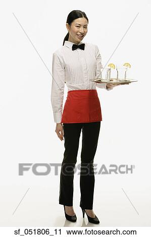 Studio shot of Asian waitress holding tray of drinks View Large Photo Image Stock Image - Studio shot of Asian waitress holding tray of drinks. Fotosearch