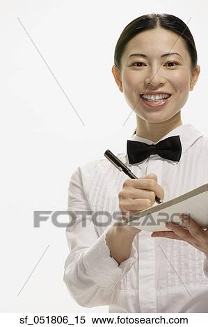 Studio shot of Asian waitress writing food order View Large Photo Image Stock Photography - Studio shot of Asian waitress writing food order. Fotosearch