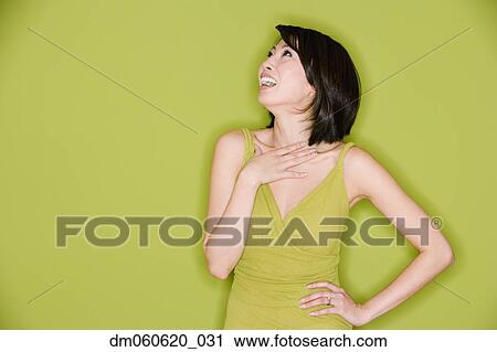 Studio shot of Asian woman looking up and laughing View Large Photo Image Stock Image - Studio shot of Asian woman looking up and laughing. Fotosearch