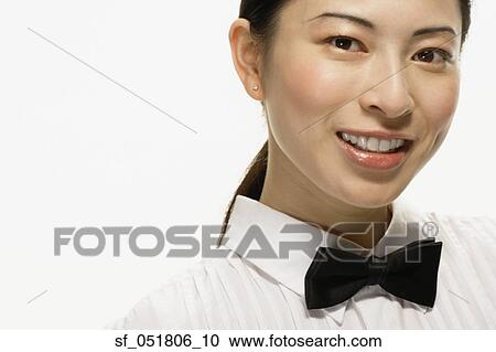 Stock Image - Studio shot of Asian woman smiling. Fotosearch