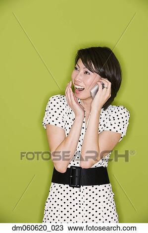 Studio shot of Asian woman using cell phone View Large Photo Image Stock Image - Studio shot of Asian woman using cell phone. Fotosearch