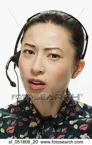 Studio shot of Asian woman wearing headset View Large Photo Image Stock Image - Studio shot of Asian woman wearing headset. Fotosearch