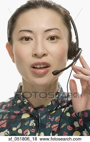 Studio shot of Asian woman wearing headset View Large Photo Image Stock Photo - Studio shot of Asian woman wearing headset. Fotosearch