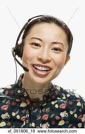Studio shot of Asian woman wearing headset View Large Photo Image Stock Photo - Studio shot of Asian woman wearing headset. Fotosearch