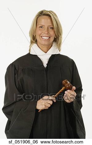 Stock Photograph - Studio shot of female judge holding gavel. Fotosearch