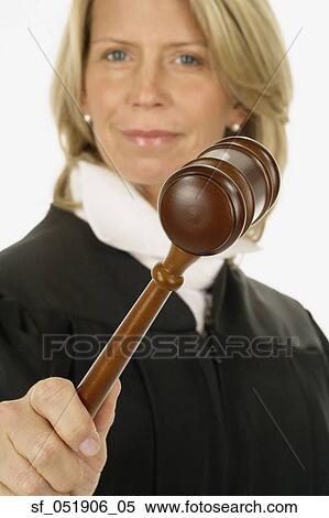 Stock Photography - Studio shot of female judge holding gavel. Fotosearch