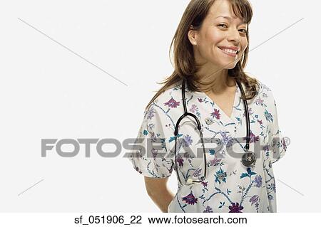 Stock Image - Studio shot of Hispanic female nurse smiling. Fotosearch