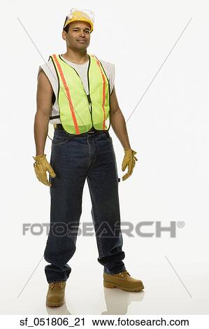 Stock Image - Studio shot of man in construction gear. Fotosearch