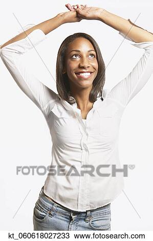 Stock Image - Studio shot of young African woman smiling. Fotosearch