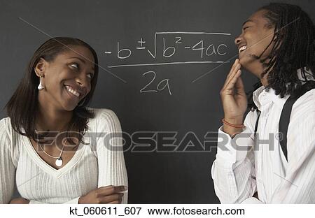 Two African students next to math problem on blackboard View Large Photo Image Stock Photo - Two African students next to math problem on blackboard. Fotosearch