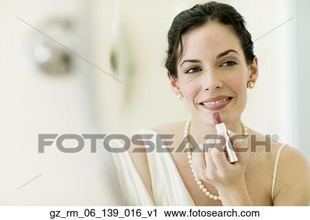 Woman in fancy clothing applying lipstick View Large Photo Image Stock Image - Woman in fancy clothing applying lipstick. Fotosearch