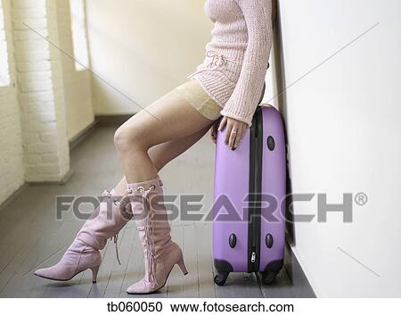 Woman in mini skirt sitting on suitcase View Large Photo Image Stock Image - Woman in mini skirt sitting on suitcase. Fotosearch