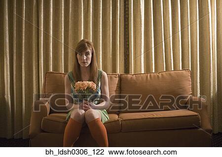 Woman sitting on sofa with bouquet of flowers View Large Photo Image Stock Image - Woman sitting on sofa with bouquet of flowers. Fotosearch