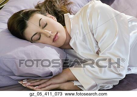 Woman sleeping in silk pajamas View Large Photo Image Stock Image - Woman sleeping in silk pajamas. Fotosearch