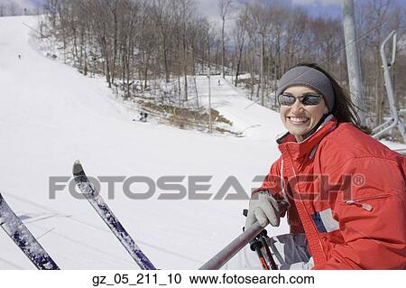 Woman smiling on ski lift View Large Photo Image Stock Image - Woman smiling on ski lift. Fotosearch