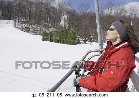 Stock Photography - Woman smiling on ski lift. Fotosearch