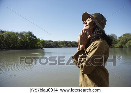 Picture - Woman smiling with sun on her face. Fotosearch